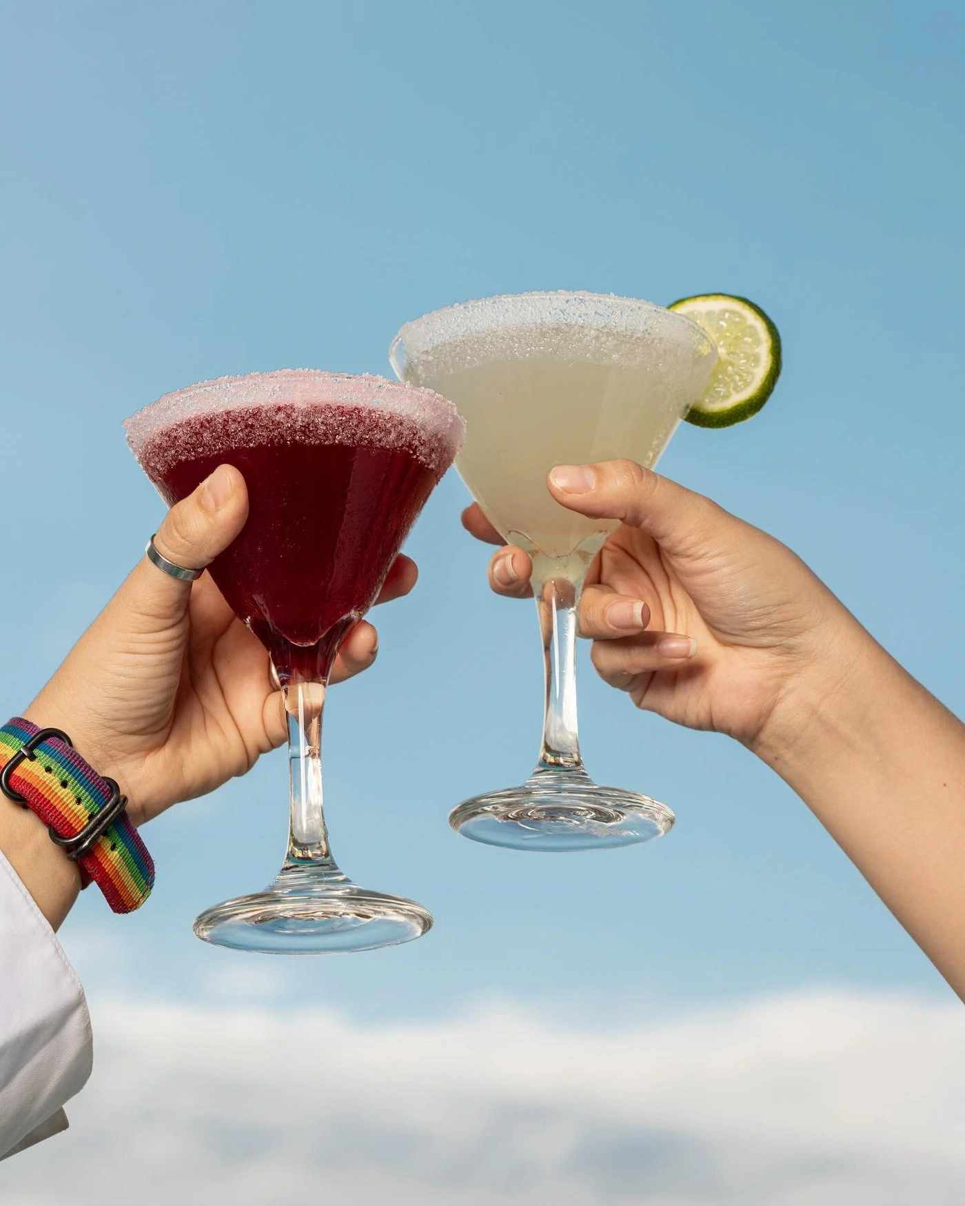 Dos margaritas brindando frente a un cielo azul