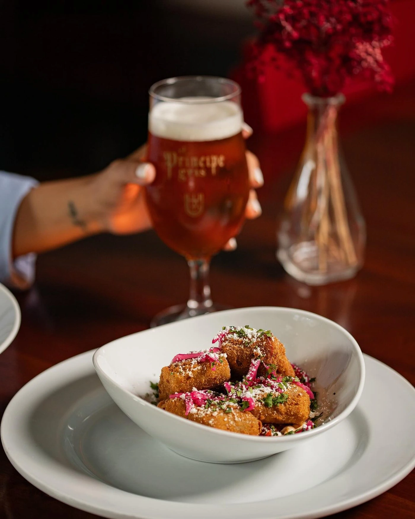 Cerveza artesanal y plato de mariscos en mesa de madera